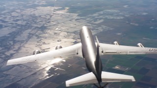 WAAF04_C020_011886 - 4K stock footage aerial video of flying around the tail of a Boeing KC-135 in flight over Northern California mountains