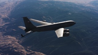 WAAF04_C029_0118JN - 4K stock footage aerial video of a Boeing KC-135 flying over mountains, lowering refueling boom, Northern California