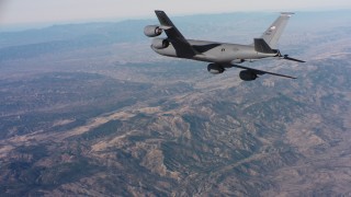 WAAF04_C033_0118M4 - 4K stock footage aerial video of a Boeing KC-135 in flight high above mountains in Northern California