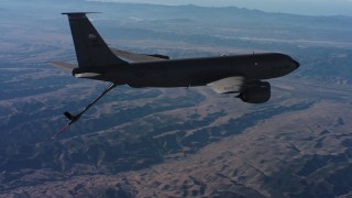 WAAF04_C036_0118W9 - 4K stock footage aerial video of a Boeing KC-135 flying high above mountains in Northern California