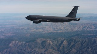 WAAF04_C049_0118DR - 4K stock footage aerial video of tracking a Boeing KC-135 over mountains in Northern California