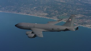WAAF04_C063_0118FX - 4K stock footage aerial video of a Boeing KC-135 over the ocean by the coast in Northern California
