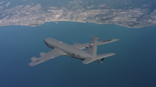 WAAF04_C064_0118TE - 4K stock footage aerial video of a Boeing KC-135 in flight over the ocean near the coast in Northern California