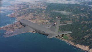 WAAF04_C069_011863 - 4K stock footage aerial video of revealing a Boeing KC-135 as it flies over coastal clouds in Northern California