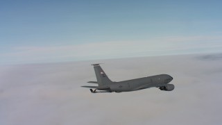 WAAF04_C077_0118V0 - 4K stock footage aerial video of a Boeing KC-135 in flight over dense clouds in Northern California