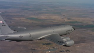 WAAF04_C090_0118SM - 4K stock footage aerial video of flying around a Boeing KC-135 over farms in Northern California