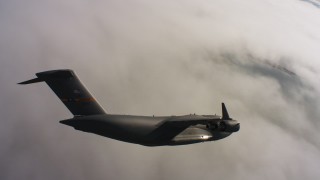 WAAF05_C003_0118D0 - 4K stock footage aerial video of a Boeing C-17 over clouds in Northern California