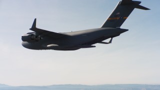 WAAF05_C017_01183V - 4K stock footage aerial video of a Boeing C-17 flying with cargo door open in Northern California