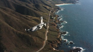 WAAF05_C044_0118LQ - 4K stock footage aerial video of a Boeing C-17 following the coast and flying out of frame, Northern California