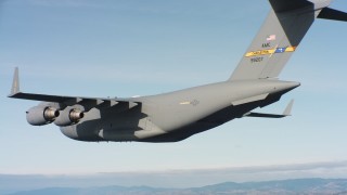 WAAF05_C058_0118SP - 4K stock footage aerial video of a Boeing C-17 with cargo doors opening in flight over Northern California 