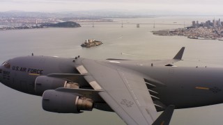 WAAF05_C067_0118DB - 4K stock footage aerial video of a Boeing C-17 flying near Alcatraz and San Francisco, California