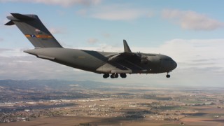 WAAF05_C076_0118DH - 4K stock footage aerial video of a Boeing C-17 near Travis Air Force Base with landing gear down, Northern California