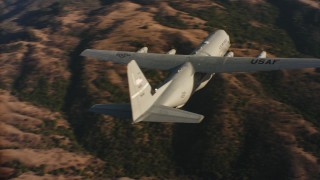 WAAF06_C021_01198P - 4K stock footage aerial video of flying around the tail of a Lockheed Martin C-130J at sunset in Northern California 