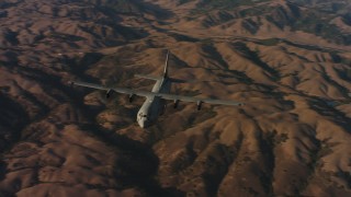 WAAF06_C024_0119KD - 4K stock footage aerial video of flying around the front of a Lockheed Martin C-130J at sunset in Northern California