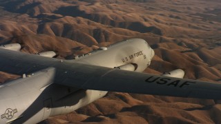 WAAF06_C031_0119QR - 4K stock footage aerial video pan across the body of a Lockheed Martin C-130J at sunset in Northern California