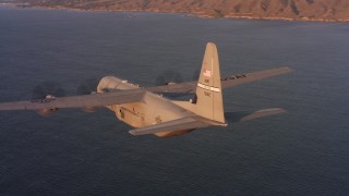 WAAF06_C059_0119W4_S000 - 4K stock footage aerial video of flying around a Lockheed Martin C-130J near the coast of Northern California at sunset