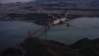WAAF06_C085_0119X1_S000 - 4K stock footage aerial video of a Lockheed Martin C-130J flying over the Marin Hills at sunset near San Francisco, California