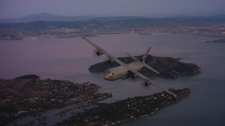 WAAF06_C085_0119X1_S001 - 4K stock footage aerial video of a Lockheed Martin C-130J over Richardson Bay at sunset in Northern California