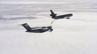 WAAF07_C050_0119C5 - 4K stock footage aerial video of a McDonnell Douglas KC-10 fueling a Boeing C-17 in flight over Northern California