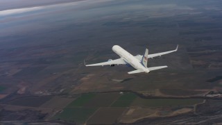 WAAF08_C020_0119PV - 4K stock footage aerial video of flying around the tail of a Boeing C-32 above farm fields in Northern California