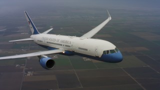 WAAF08_C025_0119Q7_S000 - 4K stock footage aerial video of a Boeing C-32 in flight above farms in Northern California