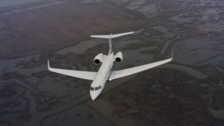 WAAF08_C036_01197J - 4K stock footage aerial video of a Gulfstream C-37A flying over rivers and marshes in Northern California 