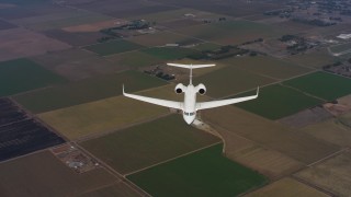 WAAF08_C044_0119CP - 4K stock footage aerial video of a Gulfstream C-37A in flight over farms in Northern California