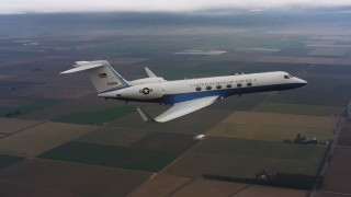 WAAF08_C051_0120V3 - 4K stock footage aerial video of a Gulfstream C-37A in the air above farmland in Northern California