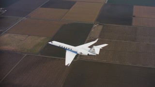 WAAF08_C058_0120H6 - 4K stock footage aerial video of a Gulfstream C-37A as it flies over fields in Northern California