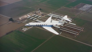 WAAF08_C060_0120A8 - 4K stock footage aerial video of Gulfstream C-37A over farms in Northern California