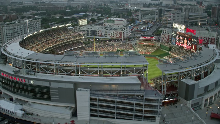 4.8K aerial stock footage flying by Nationals Park crowded with fans,  Washington, D.C., twilight Aerial Stock Footage AX76_139